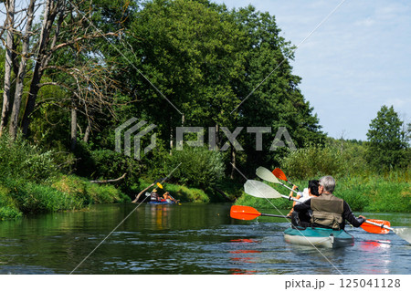 Group kayak trip for seigneur and senora. An elderly couple And adult rowing boat on the river, a water hike, a summer adventure. Age-related sports, mental youth and health, tourism, active old age 125041128