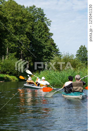 Group kayak trip for seigneur and senora. An elderly couple And adult rowing boat on the river, a water hike, a summer adventure. Age-related sports, mental youth and health, tourism, active old age 125041130