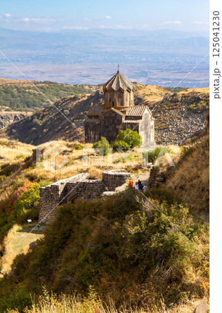 Famous view to ancient Vahramashen church of the 11th century, located near destroyed Amberd fortress in sunny summer day. Cliff with Arkashian River deep in canyon. Aragatsotn, Armenia Famous view to ancient Vahramashen church of the 11th century, located near destroyed Amberd fortress in sunny summer day. Cliff with Arkashian River deep in canyon. Aragatsotn, Armenia 125041230