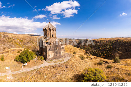 Aerial drone view of famous Vahramashen Church of the 11th century, located near destroyed Amberd fortress in sunny summer day. Cliff with Arkashian River deep in canyon. Aragatsotn region, Armenia 125041232