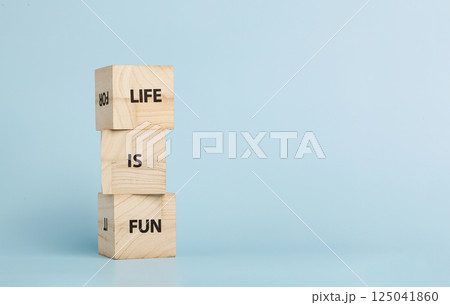 Wooden cubes with inscriptions Let Is Fun on a blue background Wooden cubes with inscriptions Let Is Fun on a blue background 125041860