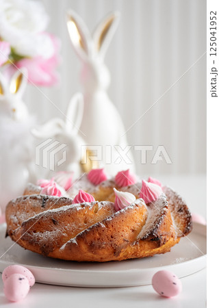 Traditional Easter cakes with icing decorated candies on white wooden table Traditional Easter cakes with icing decorated candies on white wooden table 125041952
