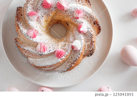 Traditional Easter cakes with icing decorated candies on white wooden table Traditional Easter cakes with icing decorated candies on white wooden table 125041955
