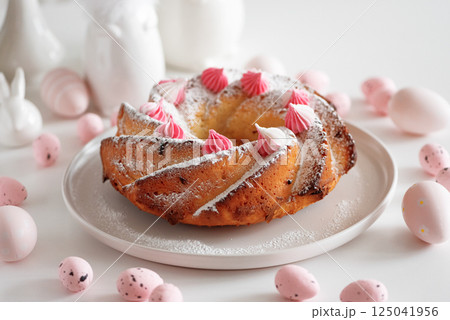 Traditional Easter cakes with icing decorated candies on white wooden table Traditional Easter cakes with icing decorated candies on white wooden table 125041956