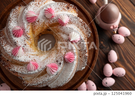 Traditional Easter cakes with icing decorated candies on dark wooden table Traditional Easter cakes with icing decorated candies on dark wooden table 125041960