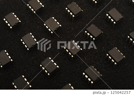 Microcircuits on black foam. Multiple chips on a substrate. Microcircuits on black foam. Multiple chips on a substrate. 125042257