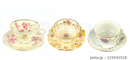 Porcelain vintage cup and saucer isolated on white background. Vintage Bavarian teaware. Porcelain vintage cup and saucer isolated on white background. Vintage Bavarian teaware. 125042528