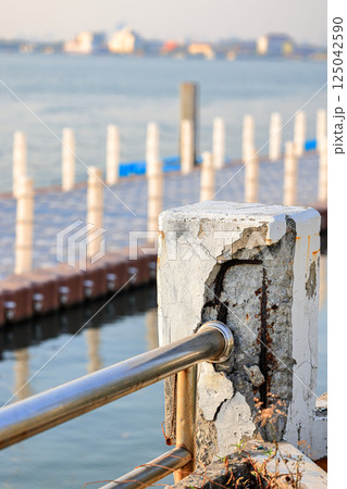 Cracked grey concrete surface with visible reinforcement, Rust in reinforcement of Concrete bridge, Broken or weak concrete. 125042590