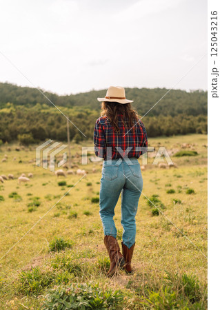 A woman wearing a plaid shirt 125043216