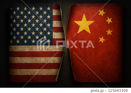 Torn flags of the United States and China on dark background, representing the fractured relationship and rising global tension between both nations 125043309
