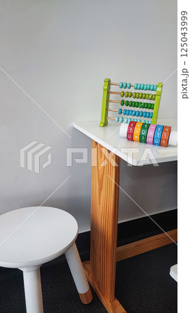 Children's wooden construction set, abacus, on a white table. Concept of children's development, montesori 125043999