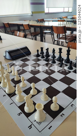 A chessboard with pieces prepared for a tournament. Concept of chess competitions, tournaments, A chessboard with pieces prepared for a tournament. Concept of chess competitions, tournaments, 125044024