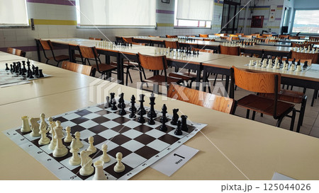 A chessboard with pieces prepared for a tournament. Concept of chess competitions, tournaments, 125044026