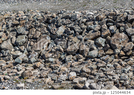 Rock revetment, riverbank stabilization, erosion control, riprap, natural stone, outdoor, daylight Rock revetment, riverbank stabilization, erosion control, riprap, natural stone, outdoor, daylight 125044634