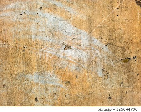 Aged beige stucco wall texture, weathered surface 125044706