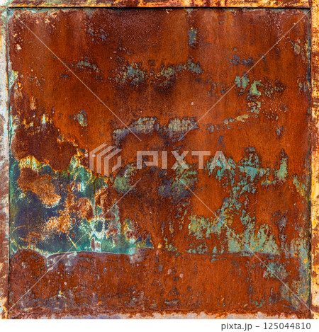 Rusty metal panel with frame and peeling green paint leftovers Rusty metal panel with frame and peeling green paint leftovers 125044810