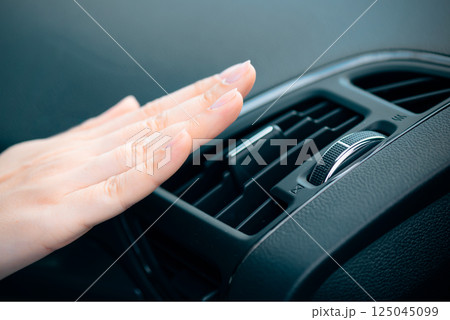 Woman check air condition in car Woman check air condition in car 125045099