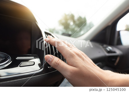 Woman check air condition in car Woman check air condition in car 125045100
