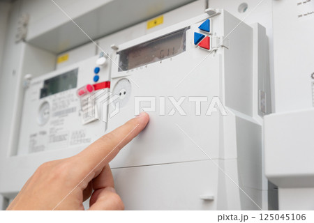 Man checking household electricity meter 125045106