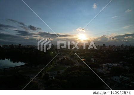 Sunset over Sao Paulo cityscape with reflections and urban activity 125045678