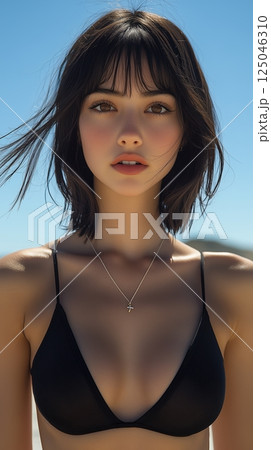 Confident woman in black bodysuit poses on rooftop against clear blue sky with basketball shoes 125046310