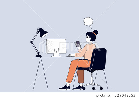 Woman Working at Computer with Phone Woman Working at Computer with Phone 125048353