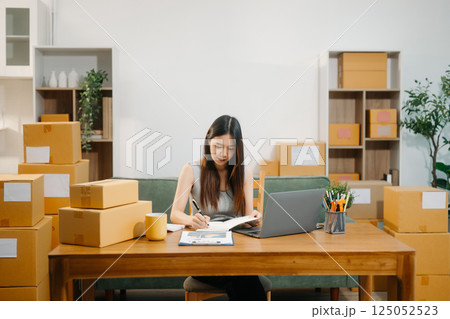 Startup small business SME, Entrepreneur owner woman using smartphone or tablet taking receive 125052523