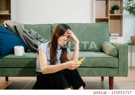 Asian Woman sitting in the sofa with a large number of pills Depressed woman wants to kill herself by drug overdose, depression concept. Asian Woman sitting in the sofa with a large number of pills Depressed woman wants to kill herself by drug overdose, depression concept. 125052717