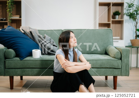 Asian woman sit Depression Dark haired pensive glance Standing by window and anxiety Copy space with a blanket Asian woman sit Depression Dark haired pensive glance Standing by window and anxiety Copy space with a blanket 125052721