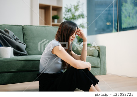 Asian woman sit Depression Dark haired pensive glance Standing by window and anxiety Copy space with a blanket Asian woman sit Depression Dark haired pensive glance Standing by window and anxiety Copy space with a blanket 125052723