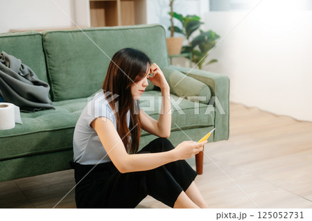 Asian Woman sitting in the sofa with a large number of pills Depressed woman wants to kill herself by drug overdose, depression concept. Asian Woman sitting in the sofa with a large number of pills Depressed woman wants to kill herself by drug overdose, depression concept. 125052731