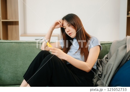 Asian Woman sitting in the sofa with a large number of pills Depressed woman wants to kill herself by drug overdose, depression concept. Asian Woman sitting in the sofa with a large number of pills Depressed woman wants to kill herself by drug overdose, depression concept. 125052733