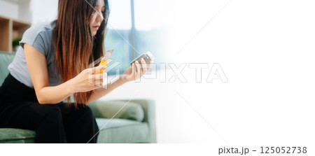 Asian Woman sitting in the sofa with a large number of pills Depressed woman wants to kill herself by drug overdose, depression concept. 125052738