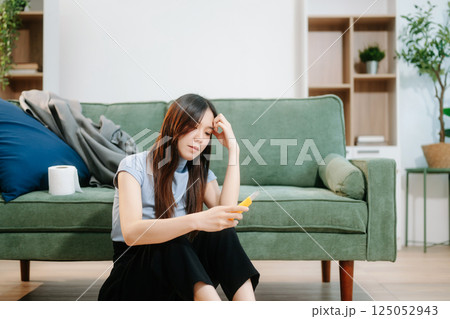 Asian Woman sitting in the sofa with a large number of pills Depressed woman wants to kill herself by drug overdose, depression concept. Asian Woman sitting in the sofa with a large number of pills Depressed woman wants to kill herself by drug overdose, depression concept. 125052943