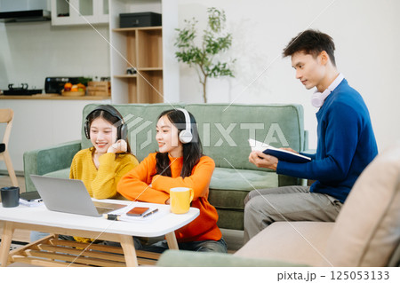 Group of young Asian college students working on his project assignment, using laptop computer 125053133