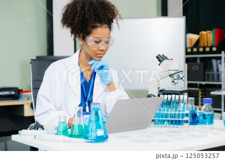 female scientist working with micro pipettes analyzing biochemical samples, advanced science chemical laboratory female scientist working with micro pipettes analyzing biochemical samples, advanced science chemical laboratory 125053257