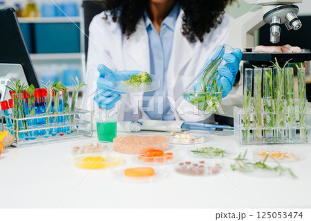 Food science as lab scientists test and analyze vegetables for safety and quality using advanced technology 125053474