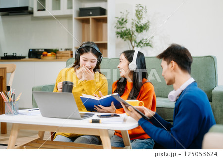 Group of young Asian college students working on his project assignment, using laptop computer Group of young Asian college students working on his project assignment, using laptop computer 125053624