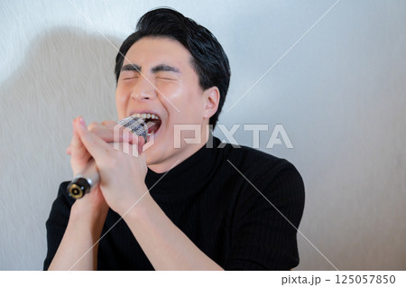 カラオケで熱唱する男性 125057850