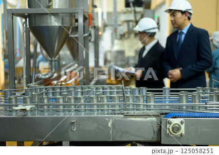 Industrial conveyor system transporting empty cans ready for filling at a seafood canning facility 125058251