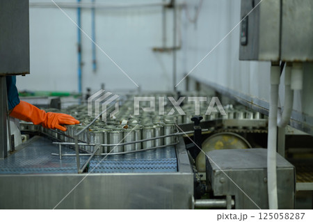 Production line carrying metal cans inside a canned fish factory Production line carrying metal cans inside a canned fish factory 125058287
