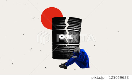 Cracked oil barrel beside man sitting in despair, economic devastation and collapse. Cracked oil barrel beside man sitting in despair, economic devastation and collapse. 125059628