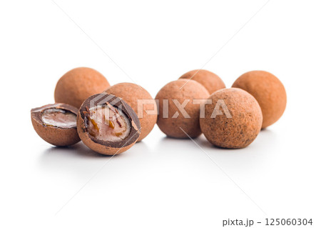 Chocolate truffles with cocoa powder and caramel filling  isolated on white background. 125060304