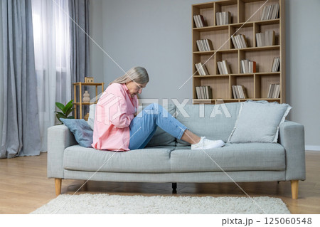 Aging woman in pink shirt feeling emotionally stressed and frustrated Aging woman in pink shirt feeling emotionally stressed and frustrated 125060548