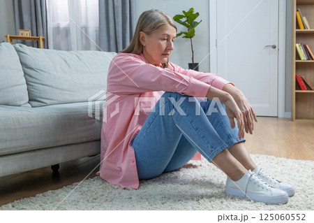 Aging woman in pink shirt feeling emotionally stressed and frustrated 125060552