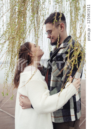 Young couple in stylish clothes on a walk. Romantic date outdoors. Walk, kisses and hugs 125061911