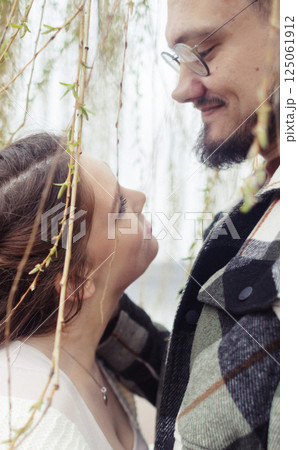 Young couple in stylish clothes on a walk. Romantic date outdoors. Walk, kisses and hugs Young couple in stylish clothes on a walk. Romantic date outdoors. Walk, kisses and hugs 125061912