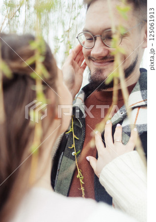 Young couple in stylish clothes on a walk. Romantic date outdoors. Walk, kisses and hugs 125061913