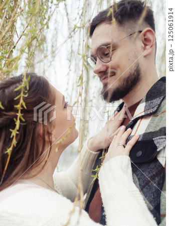 Young couple in stylish clothes on a walk. Romantic date outdoors. Walk, kisses and hugs 125061914