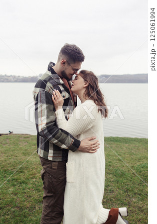 Young couple in stylish clothes on a walk. Romantic date outdoors. Walk, kisses and hugs Young couple in stylish clothes on a walk. Romantic date outdoors. Walk, kisses and hugs 125061994